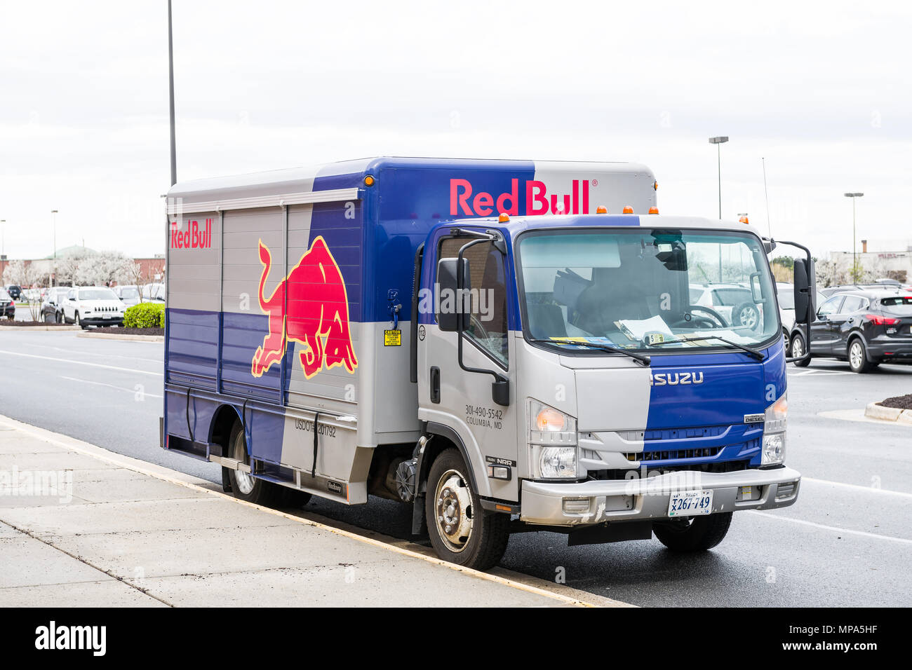 Sterling, USA - April 4, 2018: Red Bull car truck with blue red logo in Fairfax county, Virginia shopping mall closeup, Isuzu vehicle Stock Photo