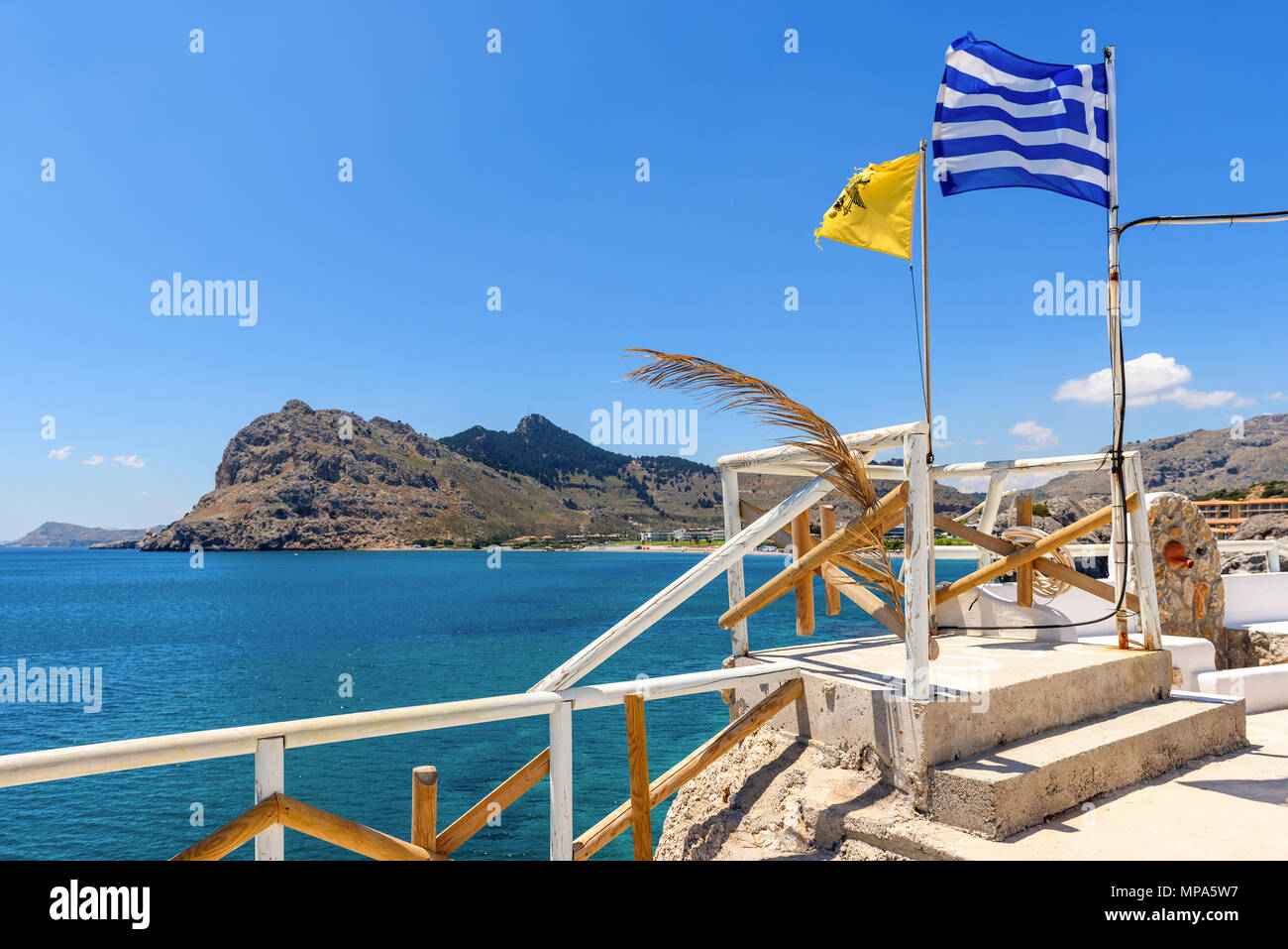 Greek flag on terrace overlooking blue sea. Kolymbia on Rhodes island