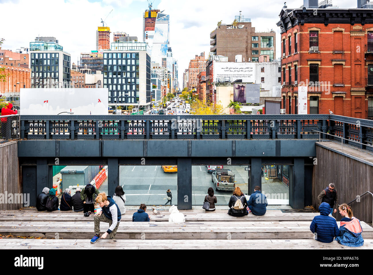 New York City, USA - October 30, 2017: Highline, high line, urban garden in NYC with many people tourists, sitting in Chelsea West Side by Hudson Yard Stock Photo