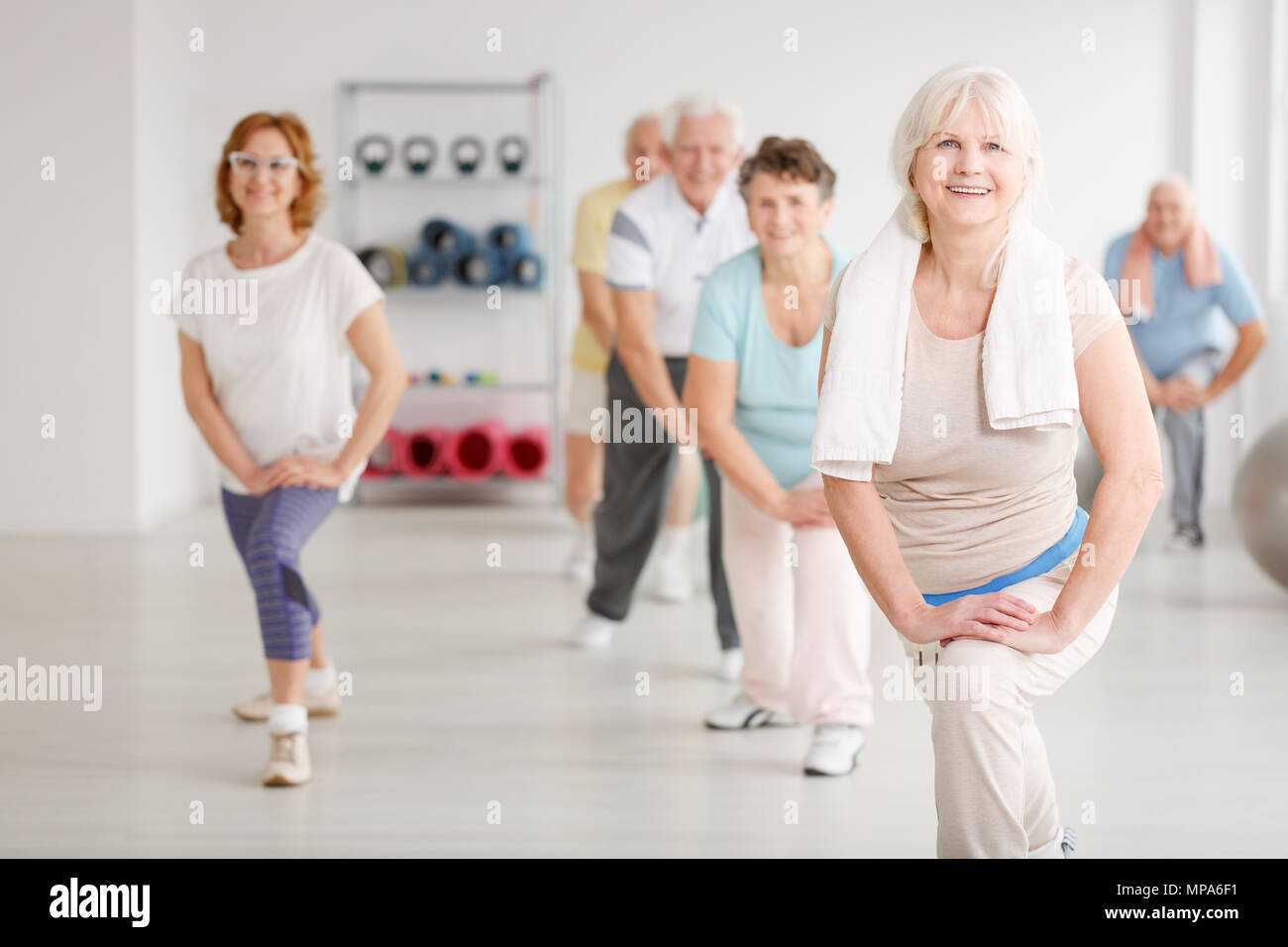 https://c8.alamy.com/comp/MPA6F1/elderly-people-exercising-in-a-group-in-fitness-club-MPA6F1.jpg