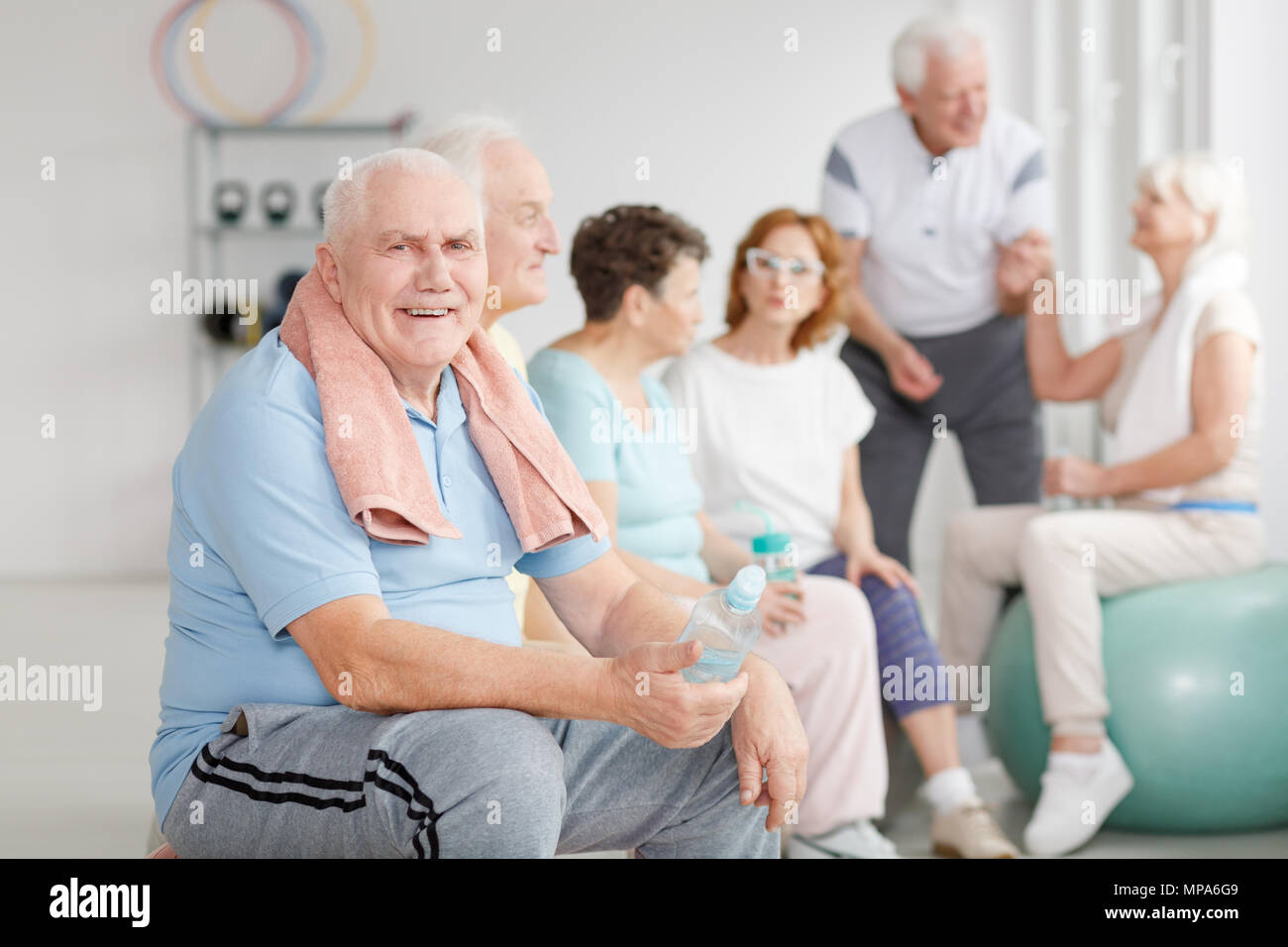 Group Of Active Senior People Talking After Training Stock Photo