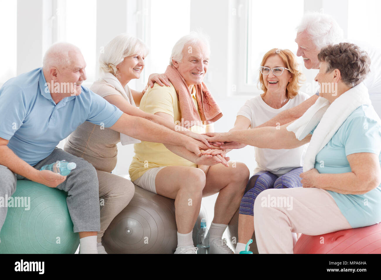 Happy active senior people congratulations each other for workout Stock ...