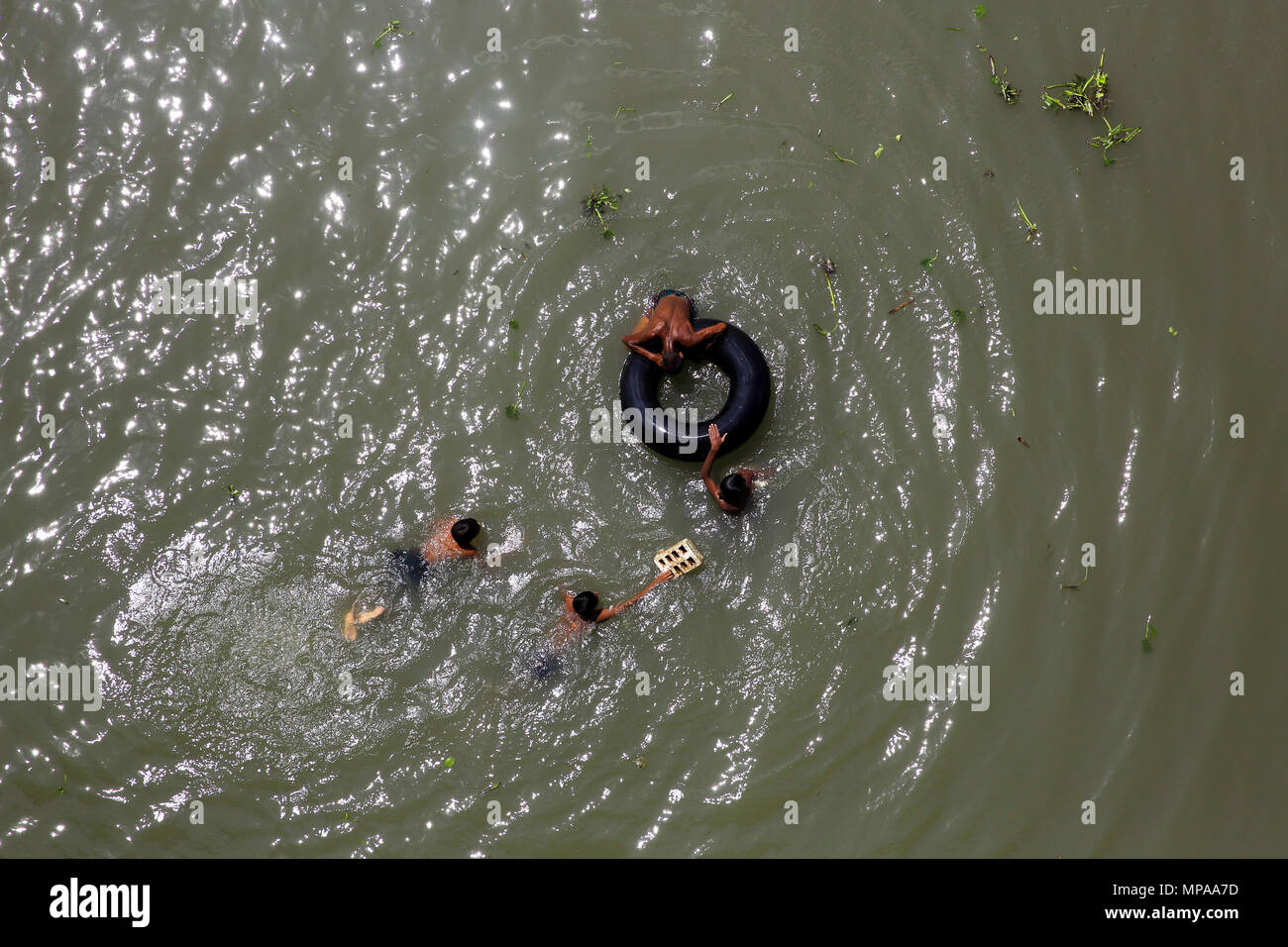 Children taking bath in the dirty water of the Buriganga River. Dhaka
