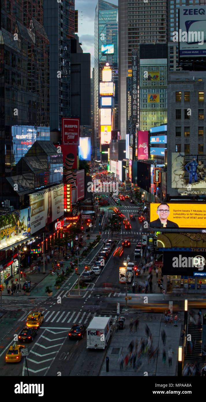 A view of Times Square in New York City during rush hour from a rooftop hotel.  Broadway is filled with taxis, delivery trucks, people and tourists. Stock Photo