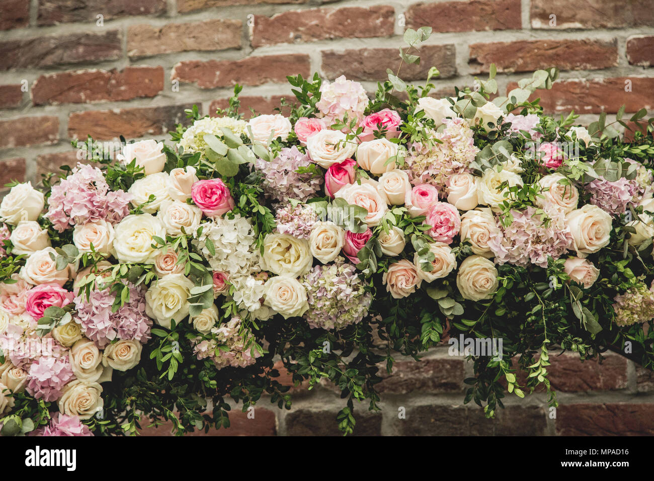 Wedding Arch Made Of Cloth And White And Pink Flowers On A Green