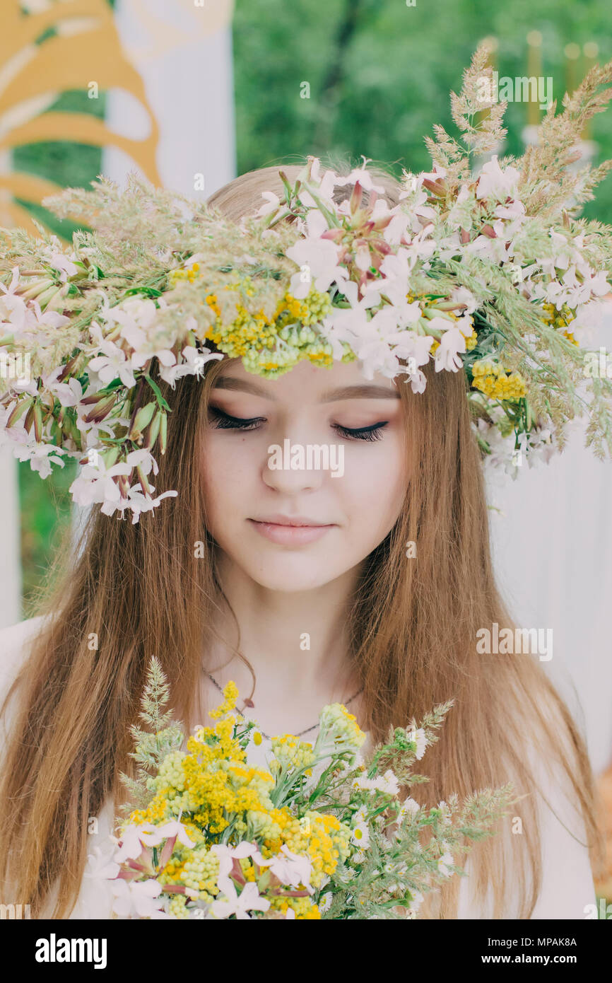 Beautiful woman with a wreath on her head from real flowers Stock Photo ...