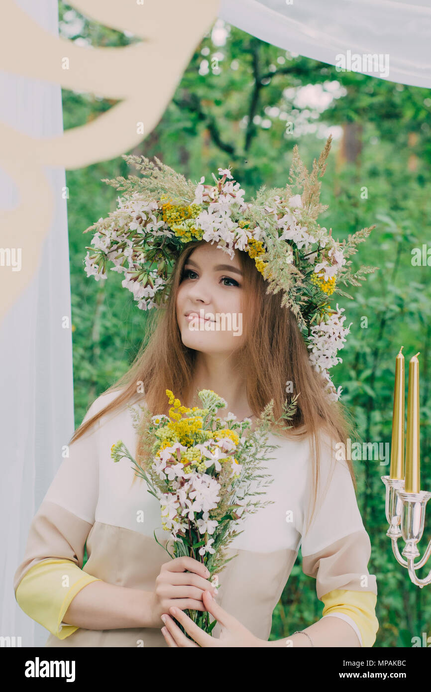 Beautiful woman with a wreath on her head from real flowers Stock Photo ...