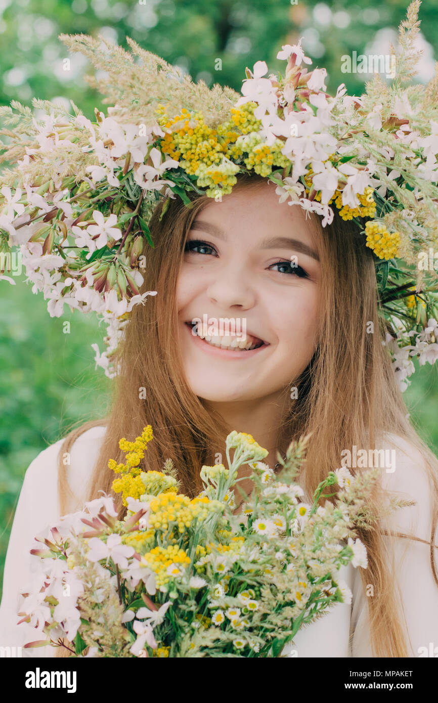 Beautiful woman with a wreath on her head from real flowers Stock Photo ...