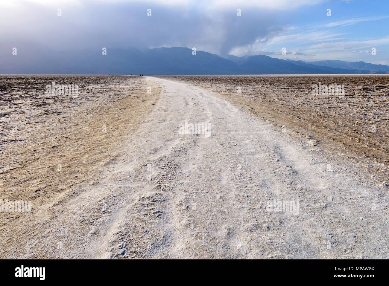 Salt Trail - A white salt footpath winding through vast salt flats of Badwater Basin at base of Panamint Range. Death Valley National Park, CA, USA. Stock Photo