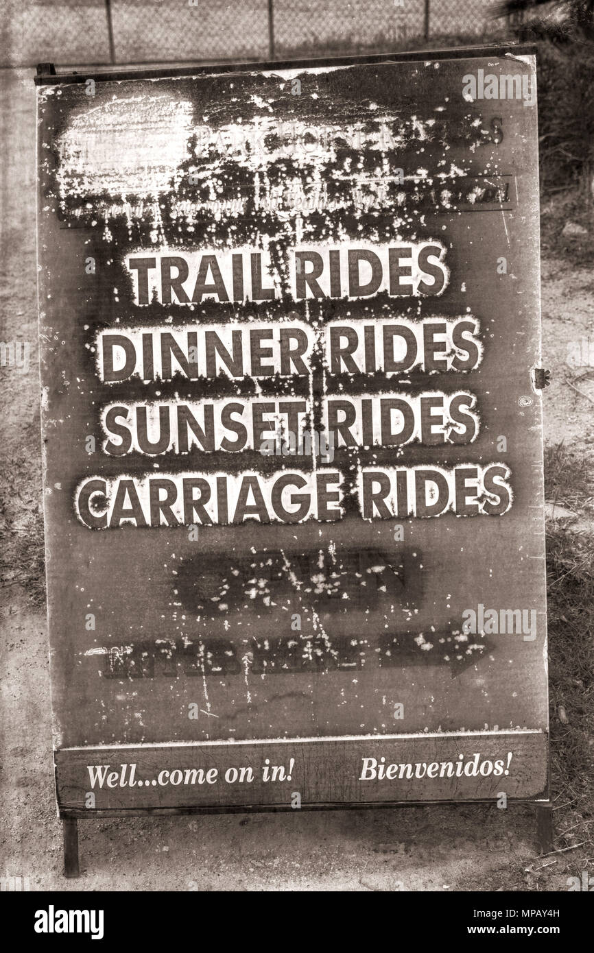 Wagon Rides Sign A photograph of a vintage weathered horse rental sign advertising Trail ...