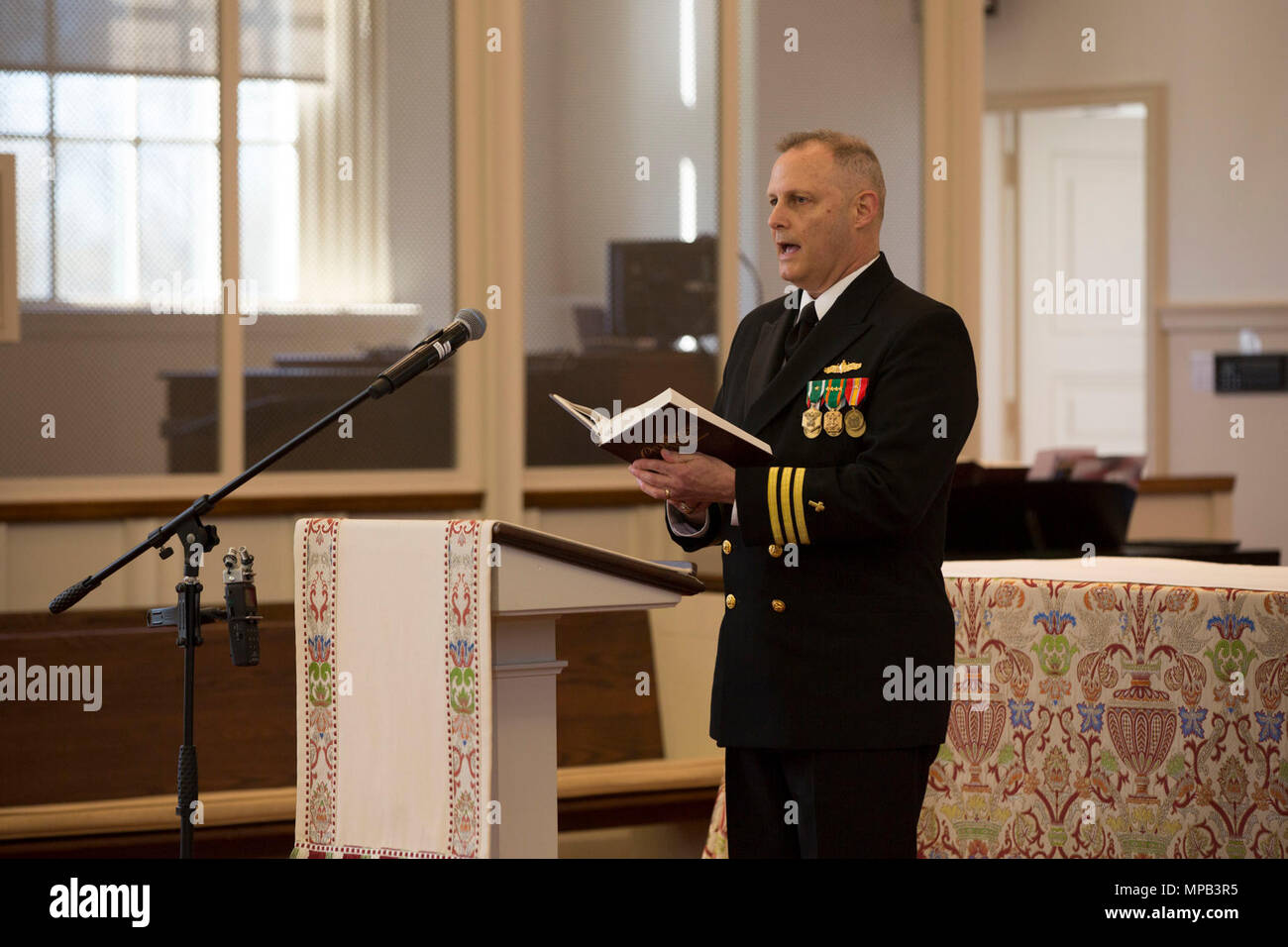 Chaplain Robert Etheridge, deputy command chaplain, Marine Corps Base Quantico, sings during the memorial service of retired U.S. Marine Corps Lt. Gen. Lawrence F. Snowden at the U.S. Marine Memorial Chapel, Quantico, Va., April 8, 2017. Snowden retired in 1979 after nearly 40 years of service, fought in engagements during World War II, the Korean War, and Vietnam. He passed away Feb. 18, 2017. He was prominently known after retirement for organizing joint 'Reunion of Honor' missions which is an opportunity for Japanese and U.S. veterans and their families, dignitaries, leaders and service mem Stock Photo