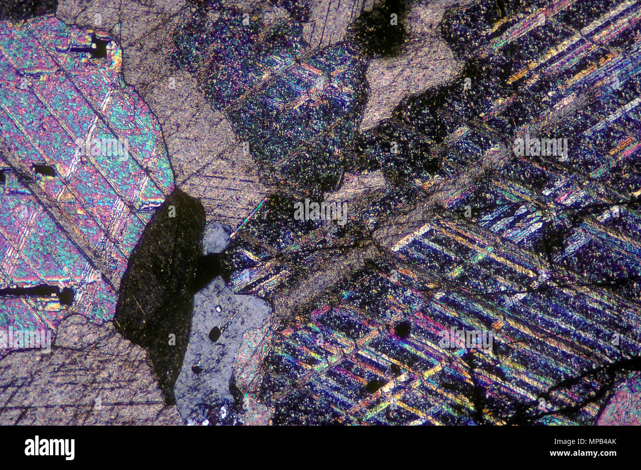 Cross Section of Pink Marble Viewed in Polarized Light Stock Photo