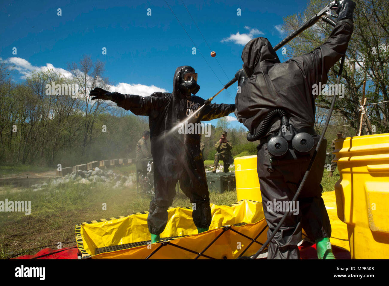 TUNNEL HILL, Ga. – Staff Sgt. Jarrod Tepe, a platoon sergeant with Personal Retrieval and Processing Company, Combat Logistics Regiment 45, 4th Marine Logistics Group, Marine Forces Reserve, gets decontaminated and sprayed down by Lance Cpl. Jacob Jones, a hazmat technician with Chemical Biological Radiological Nuclear Platoon, Combat Logistics Regiment 4, 4th Marine Logistics Group, Marine Forces Reserve, during a joint operations training exercise at Volunteer Training Site, Catoosa, Tunnel Hill, Ga., April 8, 2017. The exercise concluded by combining the CBRN Marines with the PRP Marines to Stock Photo