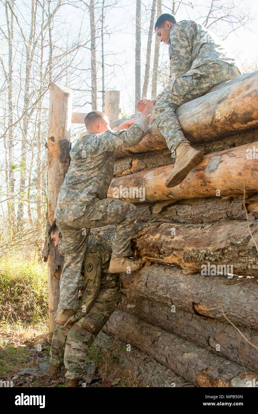 Members of the 105th Engineers Battalion, NC National Guard, clear a vertical obstacle as a team on the X-miler ruck event during the 2017 Sapper Stakes Invitational held at Camp Butner on April 9, 2017. The event brings together the engineer community to build leadership and comradery from across the state of North Carolina Guard and Reserve Component engineer units. Stock Photo