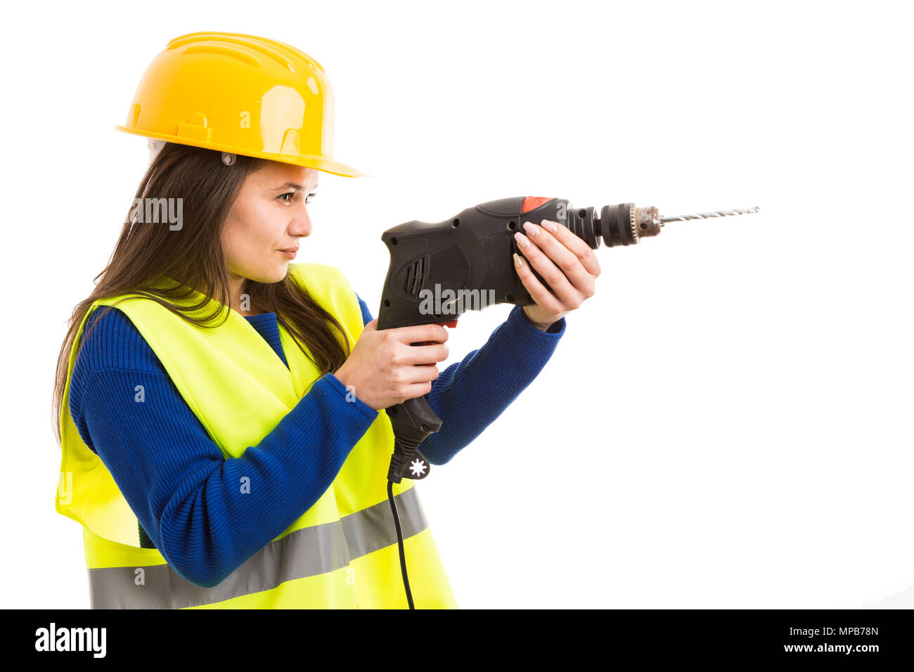 Young female engineer or architect using drilling machine as electric building tool concept isolated on white background Stock Photo