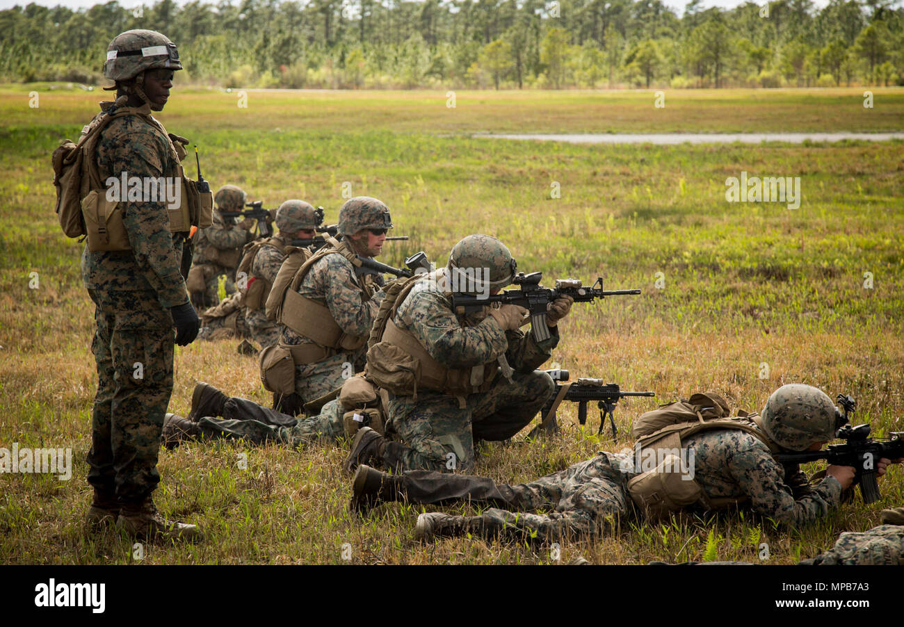 U.S. Marines attached to Advanced Infantry Training Battalion, School of Infantry-East (SOI-E), fire their weapons during a combined arms exercise at Camp Lejeune, N.C., April 7, 2017. The mission of SOI-E is to train entry-level and advanced level Marines in the skills required of an Infantry Marine for the operating forces. Stock Photo