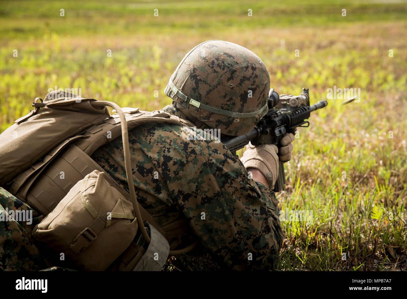 A U.S. Marine attached to Advanced Infantry Training Battalion, School of Infantry-East (SOI-E), fires an M4A1 carbine during a combined arms exercise at Camp Lejeune, N.C., April 7, 2017. The mission of SOI-E is to train entry-level and advanced level Marines in the skills required of an Infantry Marine for the operating forces. Stock Photo