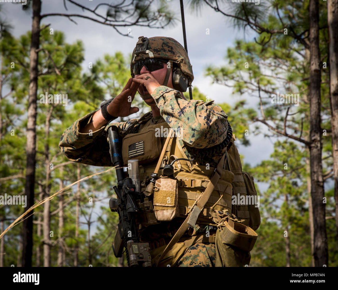 A U.S. Marine attached to Advanced Infantry Training Battalion, School of Infantry-East (SOI-E), shouts commands  during a combined arms exercise at Camp Lejeune, N.C., April 7, 2017. The mission of SOI-E is to train entry-level and advanced level Marines in the skills required of an Infantry Marine for the operating forces. Stock Photo