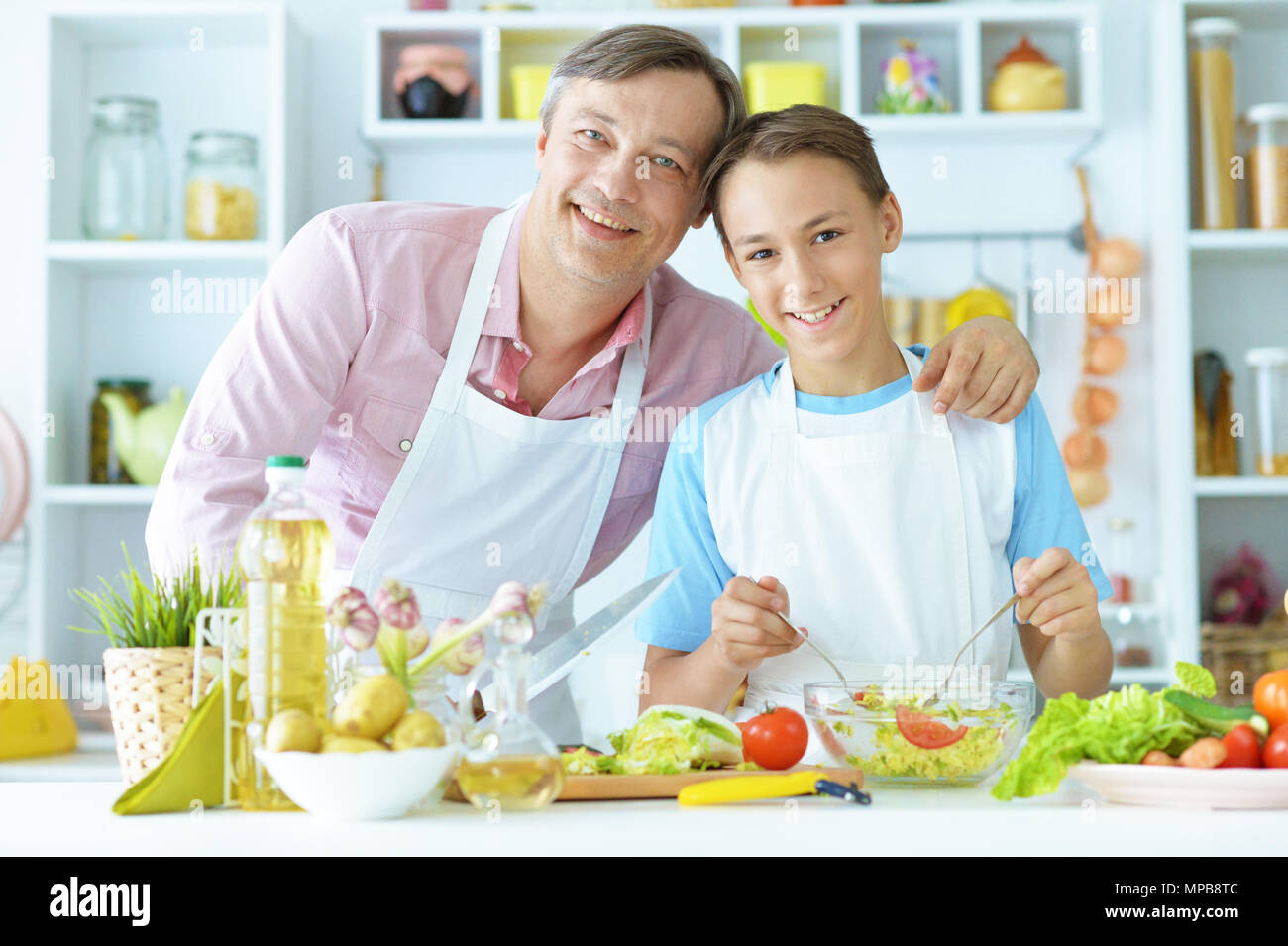 father and son in the kitchen preparing Stock Photo - Alamy