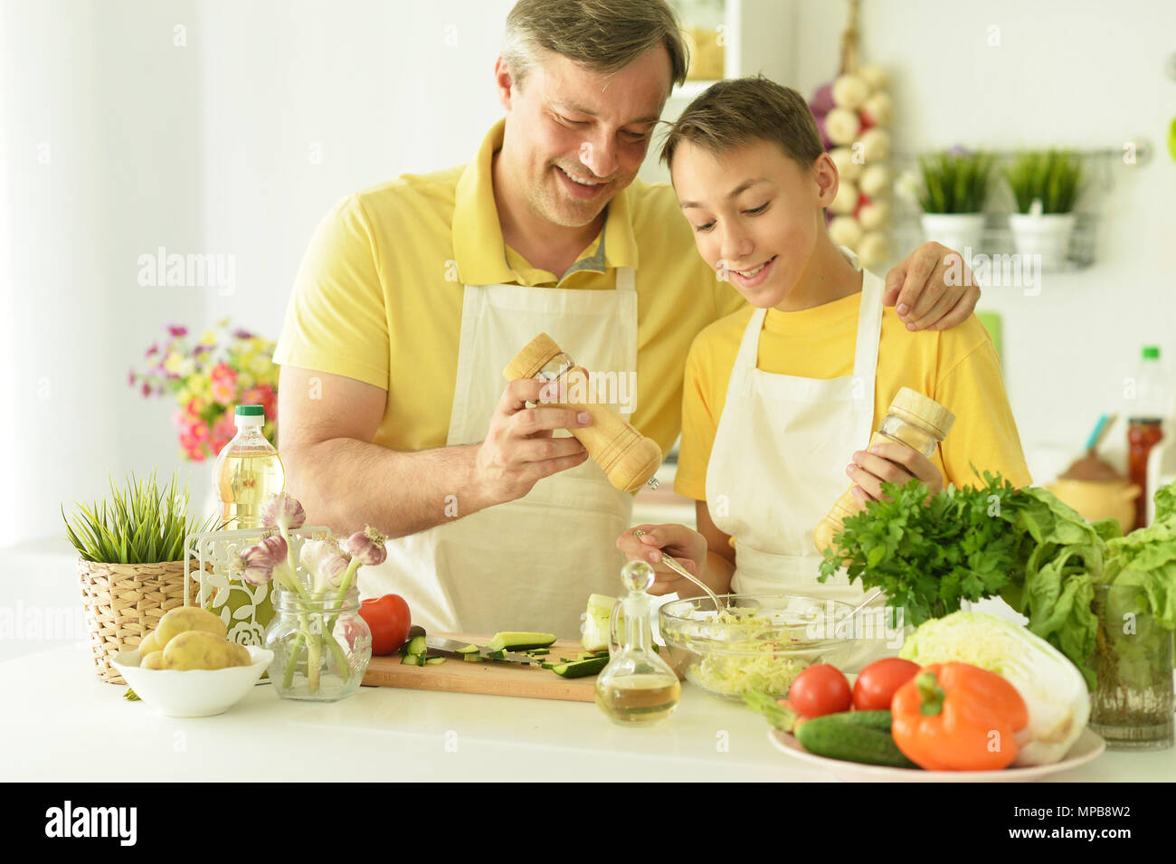 father and son cooking in the kitchen Stock Photo - Alamy
