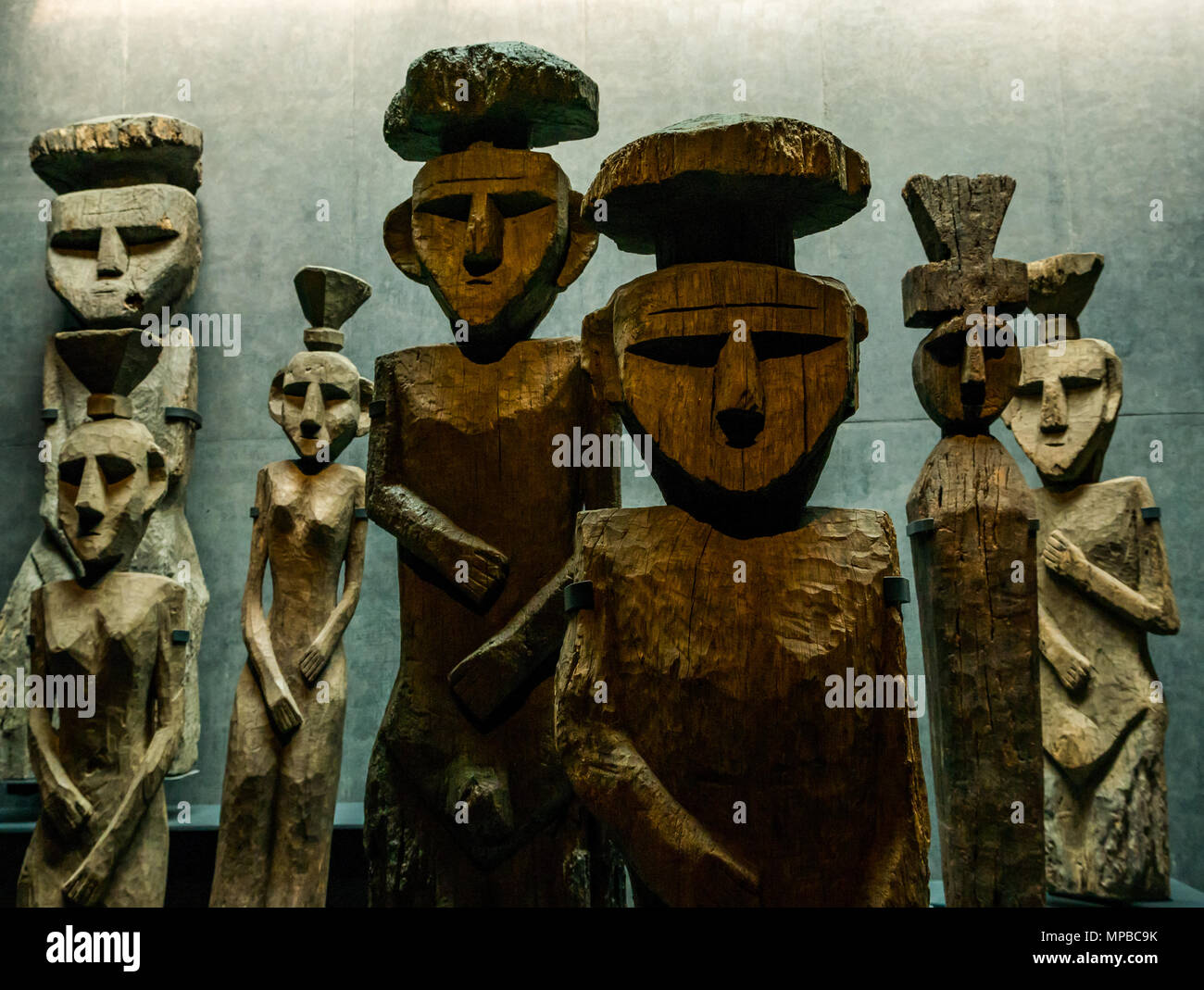 Exhibit in Museum of Pre-Columbiam Art, Santiago, Chile. Wooden figures with top knots, called Chemamulles, found at Andean culture Mapuche cemeteries Stock Photo