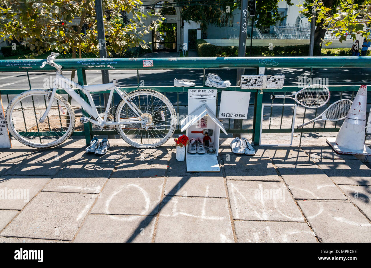 Memorial shrine by a collective art group, with white painted bike, shoes and racquets, Racamalac bridge over River Mapocho, Santiago, Chile Stock Photo