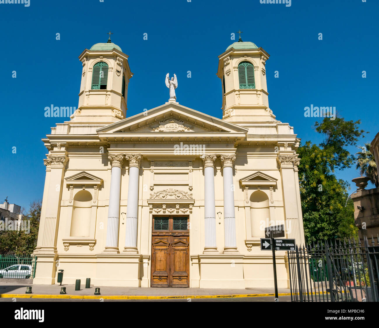 Historic yellow Holy Guardian Angels parish Catholic church with ornate bell towers, Providencia, Santiago, Chile Stock Photo