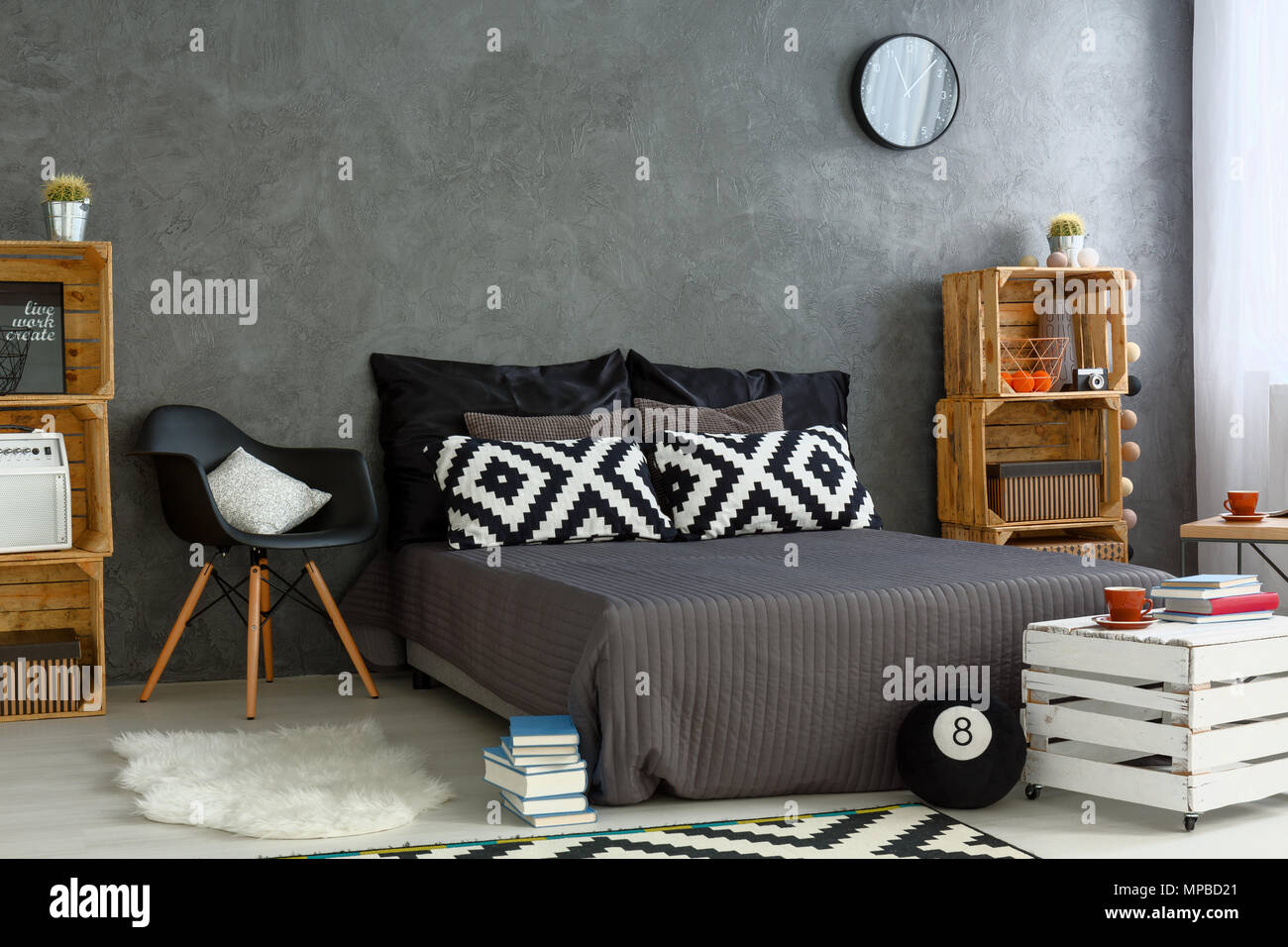 https://c8.alamy.com/comp/MPBD21/spacious-bedroom-in-grey-with-handmade-wood-furniture-big-bed-and-decorative-pattern-pillows-MPBD21.jpg