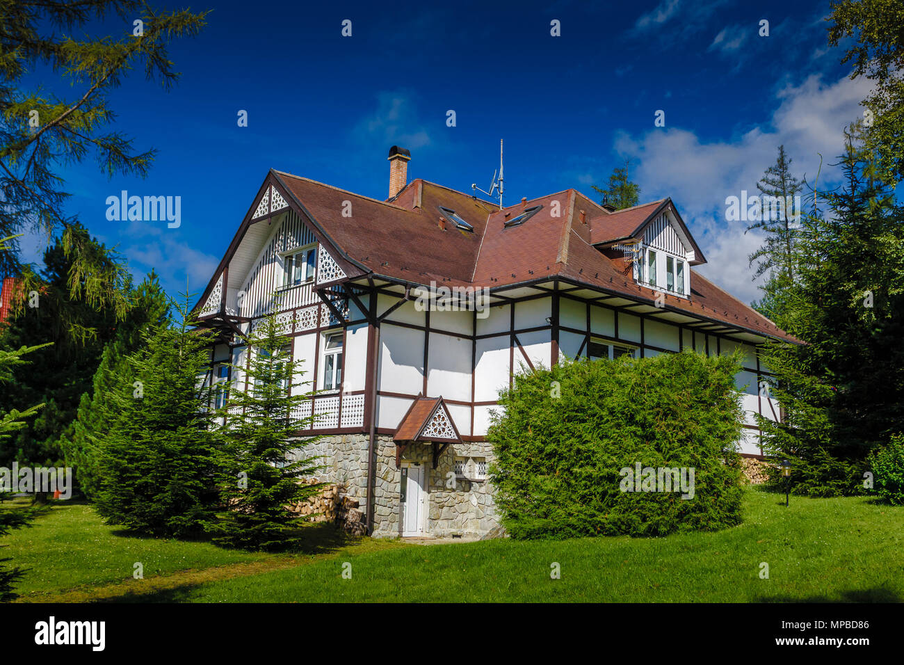 Attractive vacation holiday house in the Tatras Mountains in Slovakia. Lonely chalet surrounded by the virgin nature. Rustic charm of the all-season resort. Stock Photo