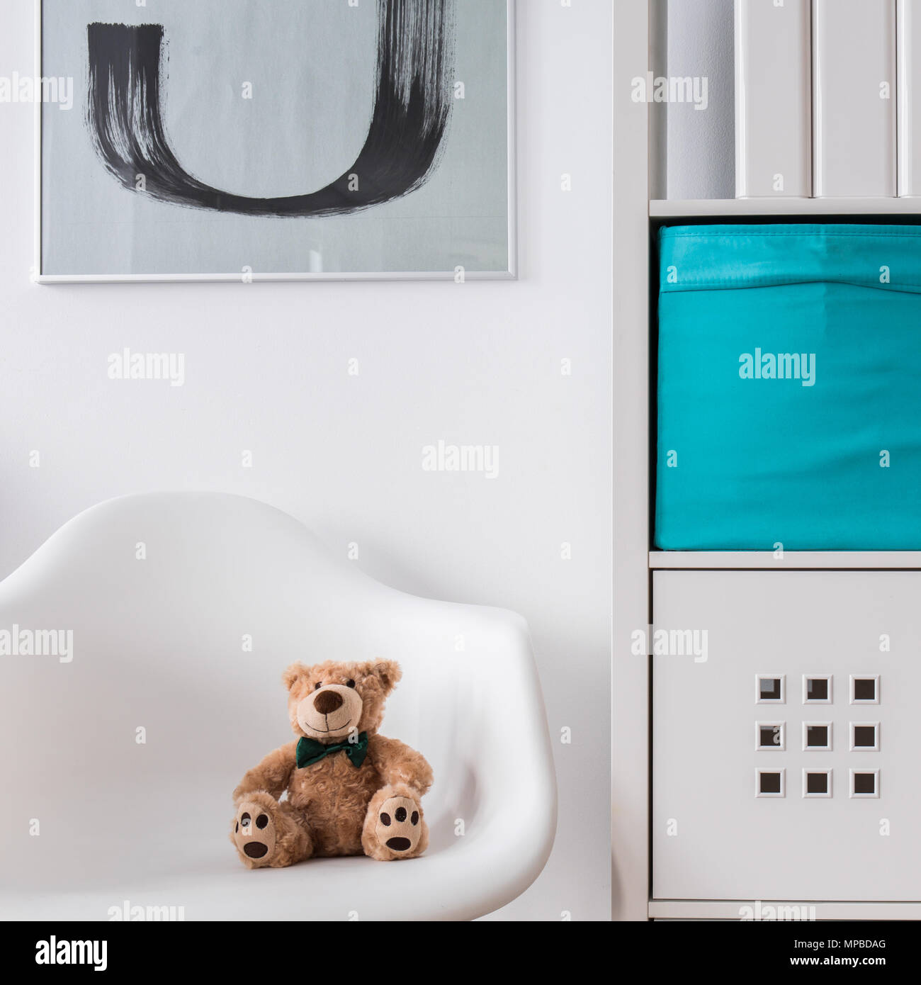 White wood regale and chair with toy in child room Stock Photo
