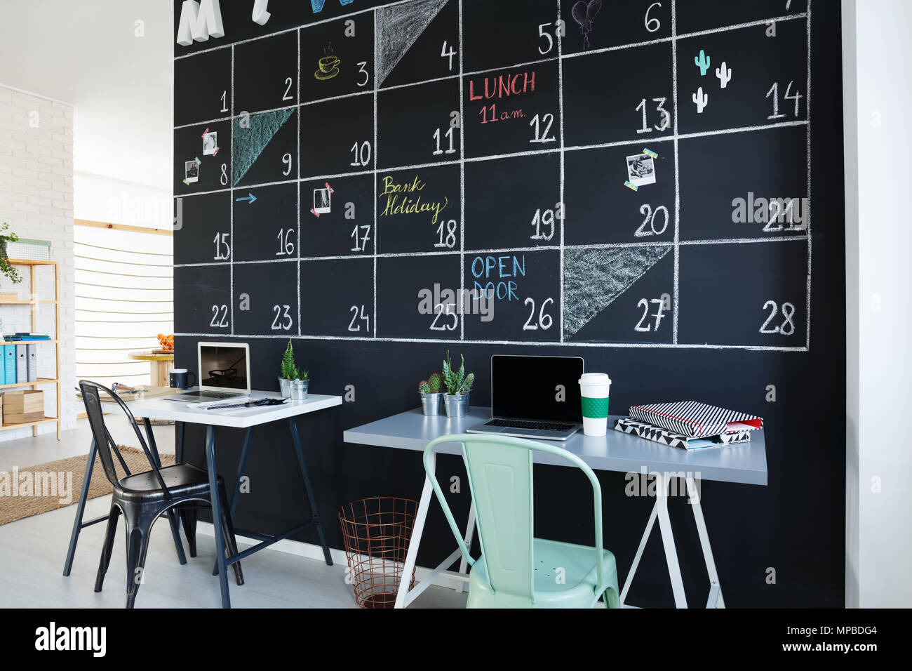 Office interior with creative blackboard calendar, desks and chairs Stock  Photo - Alamy