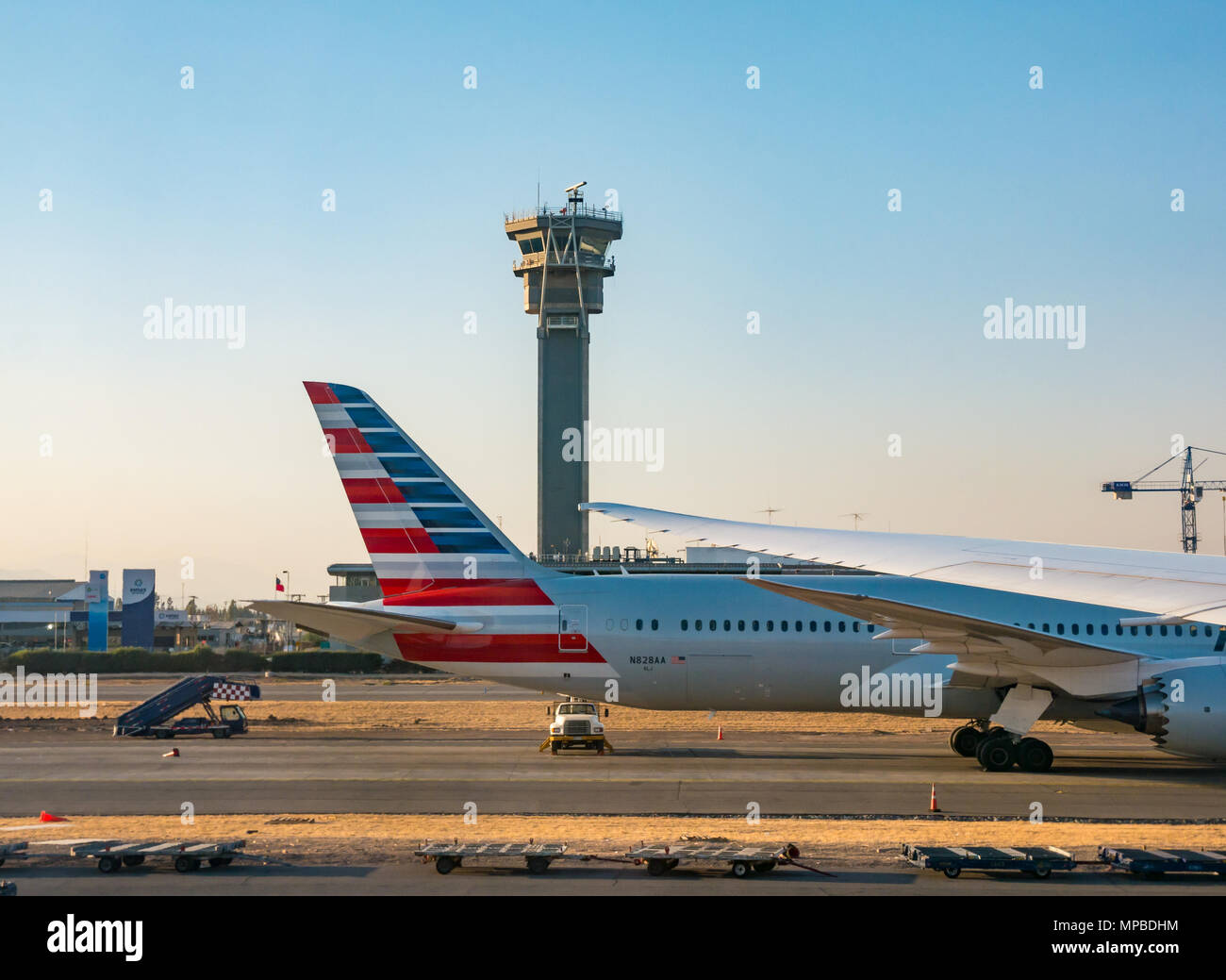 American Airlines Boeing 787 Dreamliner aeroplane on airport apron in front of control tower, Santiago International airport, Chile Stock Photo