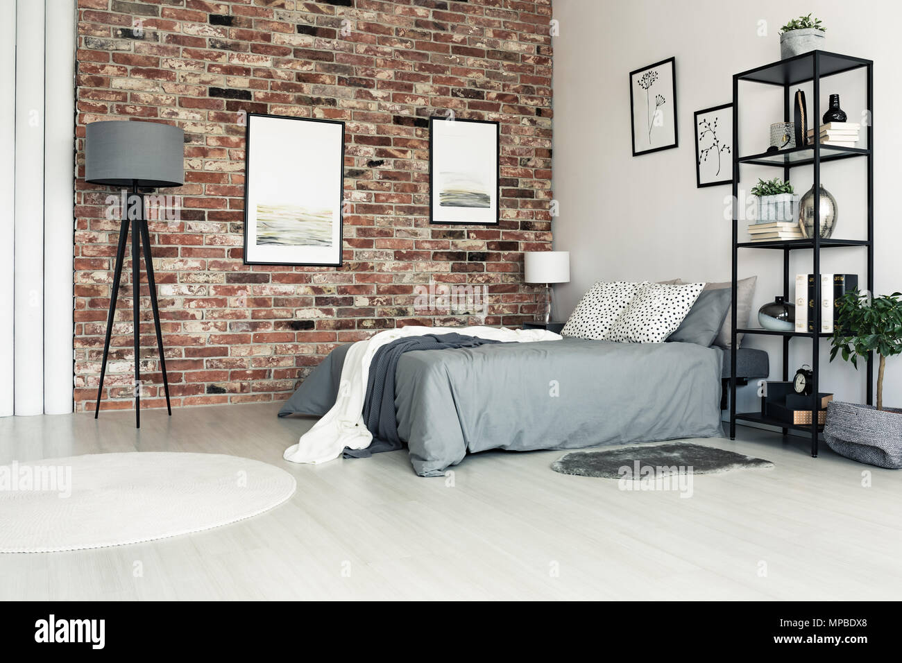 Lamp And White Carpet In Grey Bedroom With Bright Pillows On