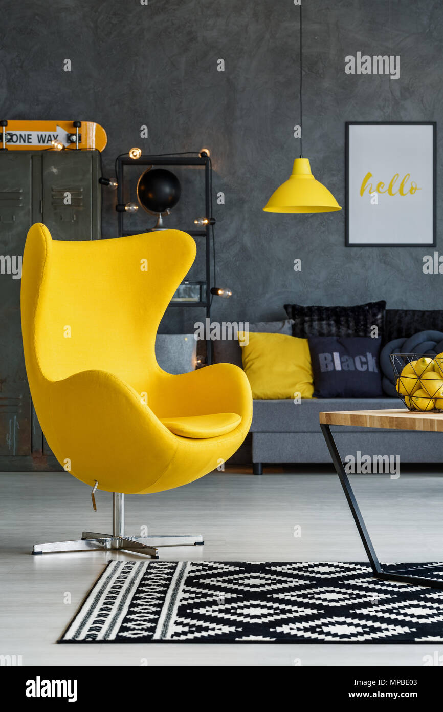 Gray living room with yellow details, armchair, sofa and coffee table Stock  Photo - Alamy