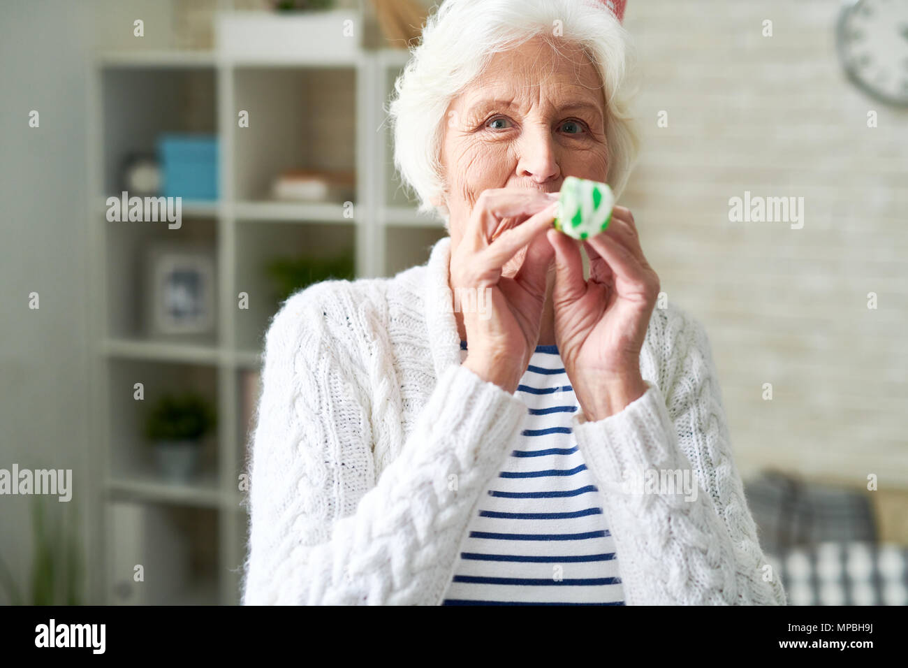 Happy Senior Lady Celebrating Holiday Stock Photo