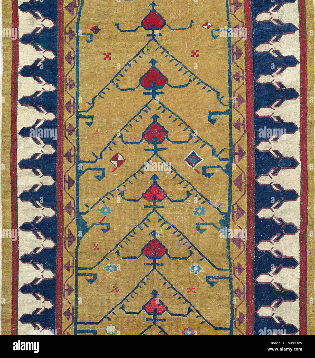 . English: Lot 312 – North West Persian Runner (detail), late 18th century .Even light overall wear, scattered repiling and restoration, reduced in length. 13ft.4in. x 3ft.5in. (407cm. x 105cm.) £15,000-20,000 . late 18th century. Unknown Persian weavers. Photo by auctoneer 933 North West Persian Runner detail Stock Photo