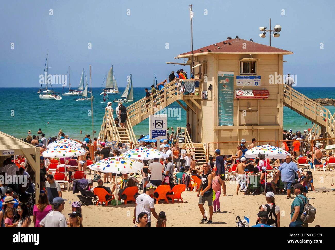 TEL AVIV, ISRAEL. April 19, 2018. Tourists and swimmers at the famous Tel Aviv Geula beach with a safe guard beach station. Baywatch coast guard tower Stock Photo