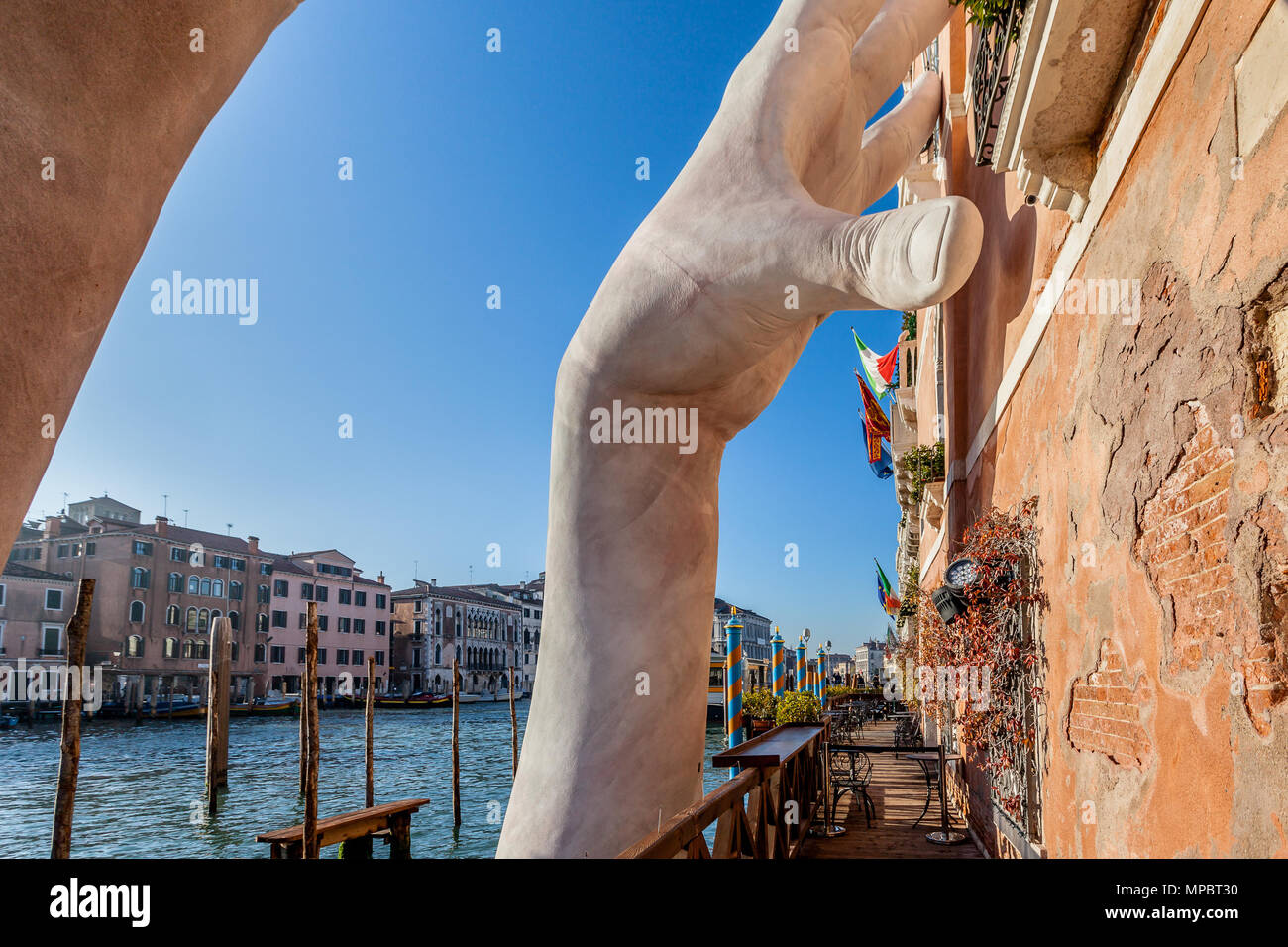 VENICE, ITALY - JANUARY 02 2018: Lorenzo Qinn scuplture exhibition at Ca Sagredo.  The sculpture symbolizes the support for the palaces of Venice that Stock Photo