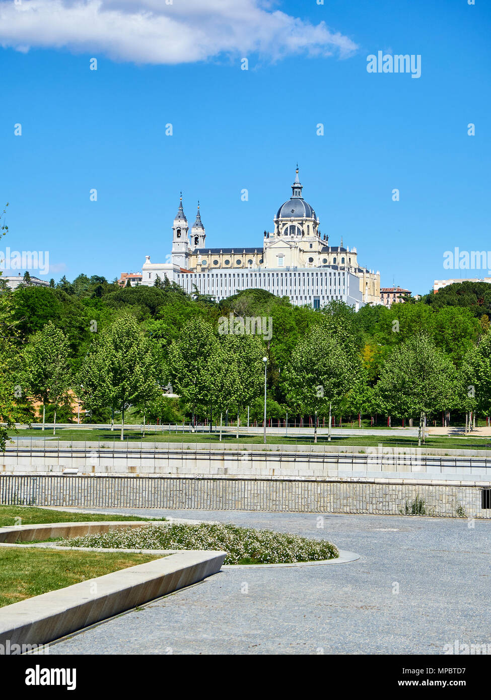 Green spaces of Madrid Rio at spring day with the Almudena Cathedral in background. Madrid, Spain. Stock Photo