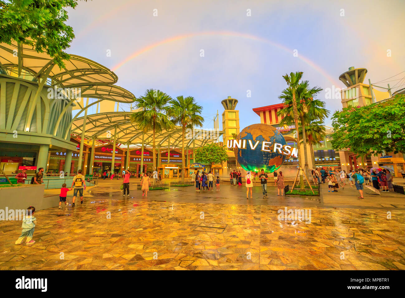 Singapore - May 2, 2018: Sentosa Bull Ring square with Universal Studios world globe in a rainbow at sunset. Famous place for holidays.Universal Studios is the first Hollywood movie theme park in Asia Stock Photo