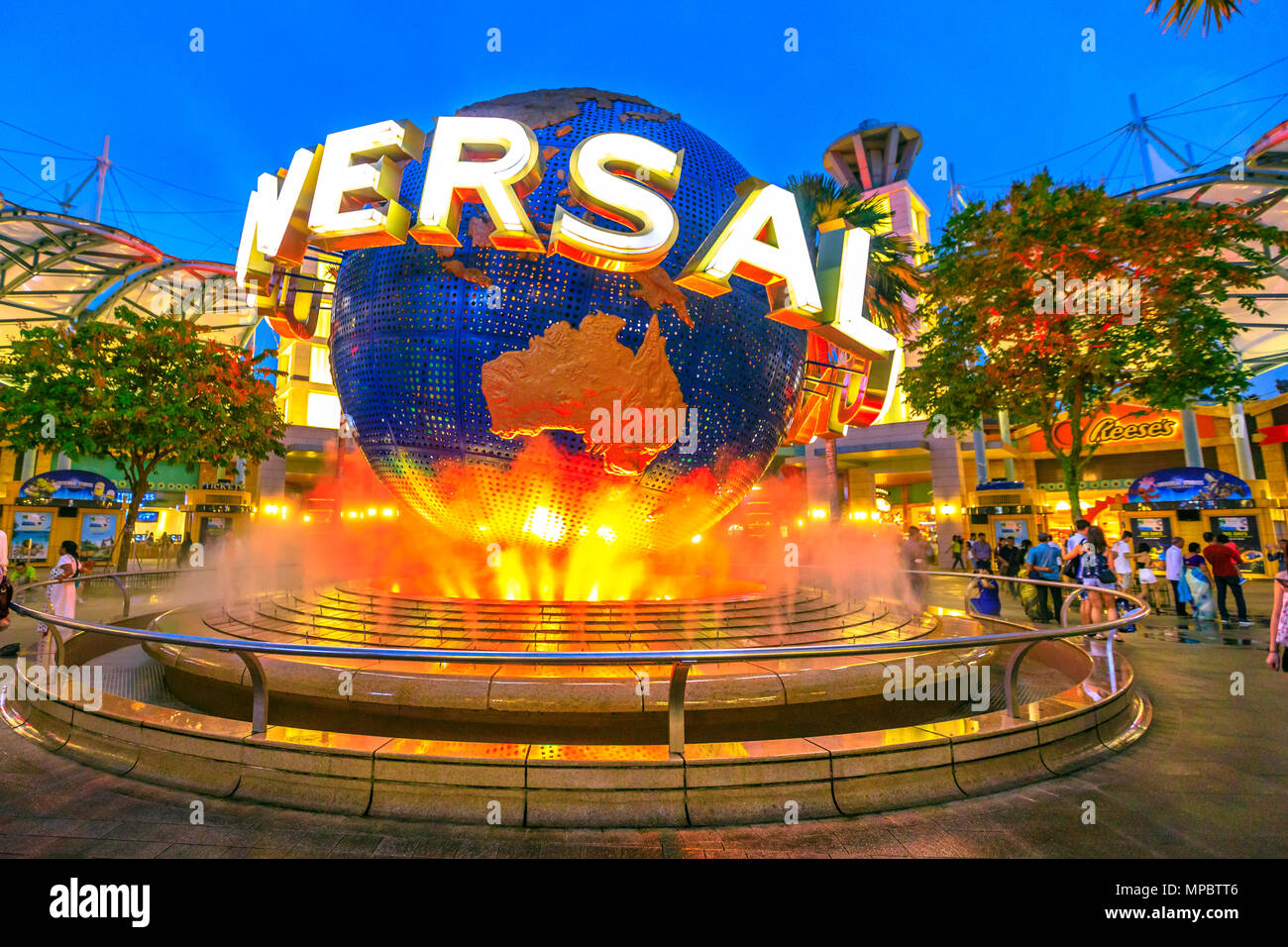 Singapore - May 2, 2018: Sentosa Universal Studios globe at night with orange lights. Universal Studios Singapore is Southeast Asia's first Hollywood movie theme park. Popular tourist attraction. Stock Photo