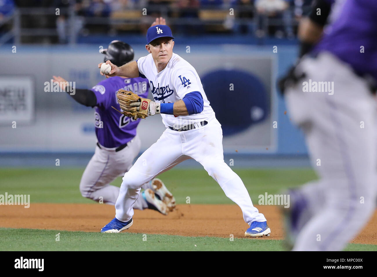 Los Angeles, CA, USA. 21st May, 2018. Los Angeles Dodgers second baseman Chase  Utley (26) fields a grounder to second but gets confused as Colorado  Rockies third baseman Nolan Arenado (28) runs
