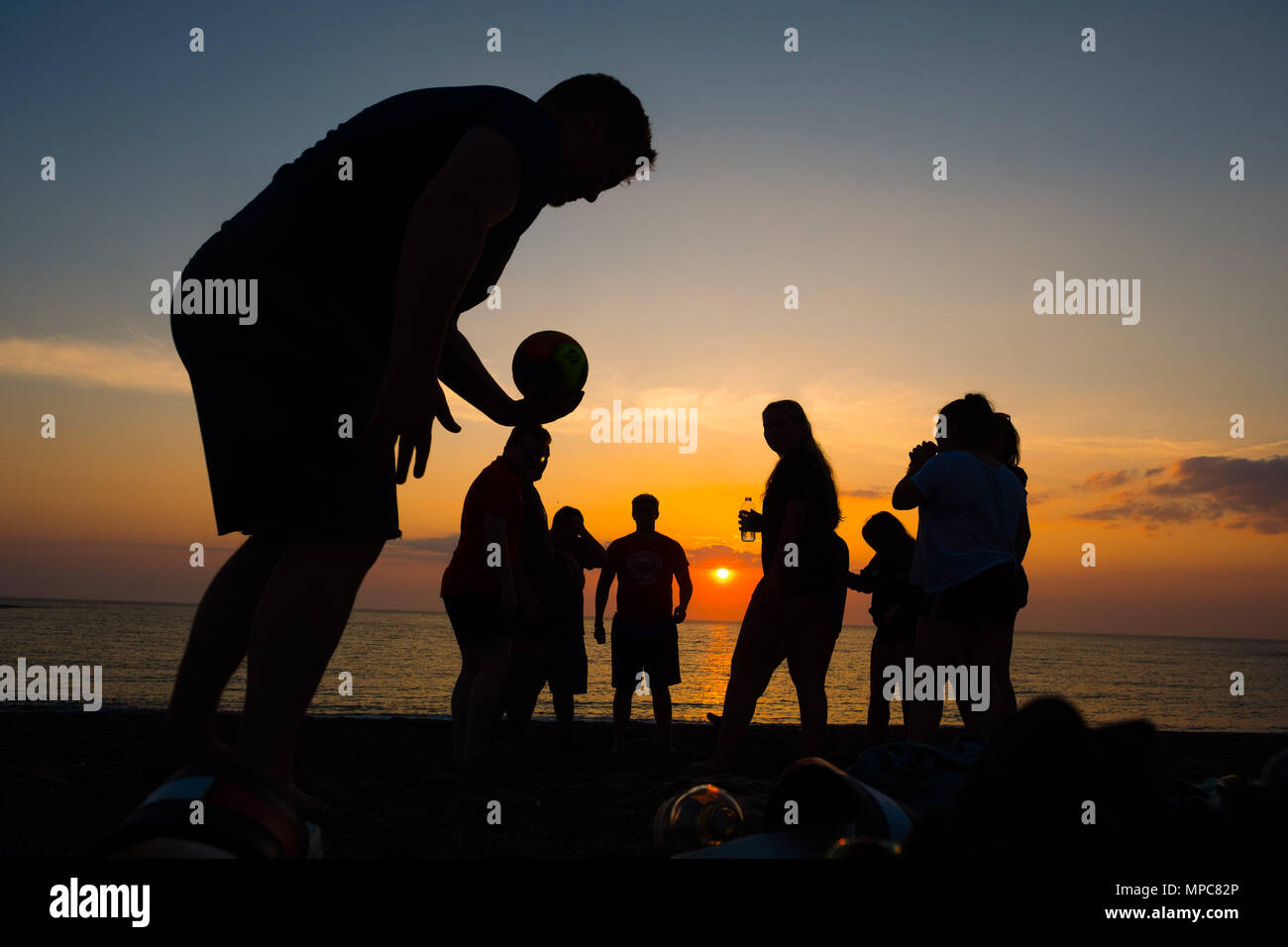 Aberystwyth  Wales UK, Tuesday 22 May 2018  UK Weather: A group of university students playing ball games on the beach are silhouetted against the setting sun in Aberystwyth, at the end of a day of warm spring sunshine   photo © Keith Morris / Alamy Live News Stock Photo