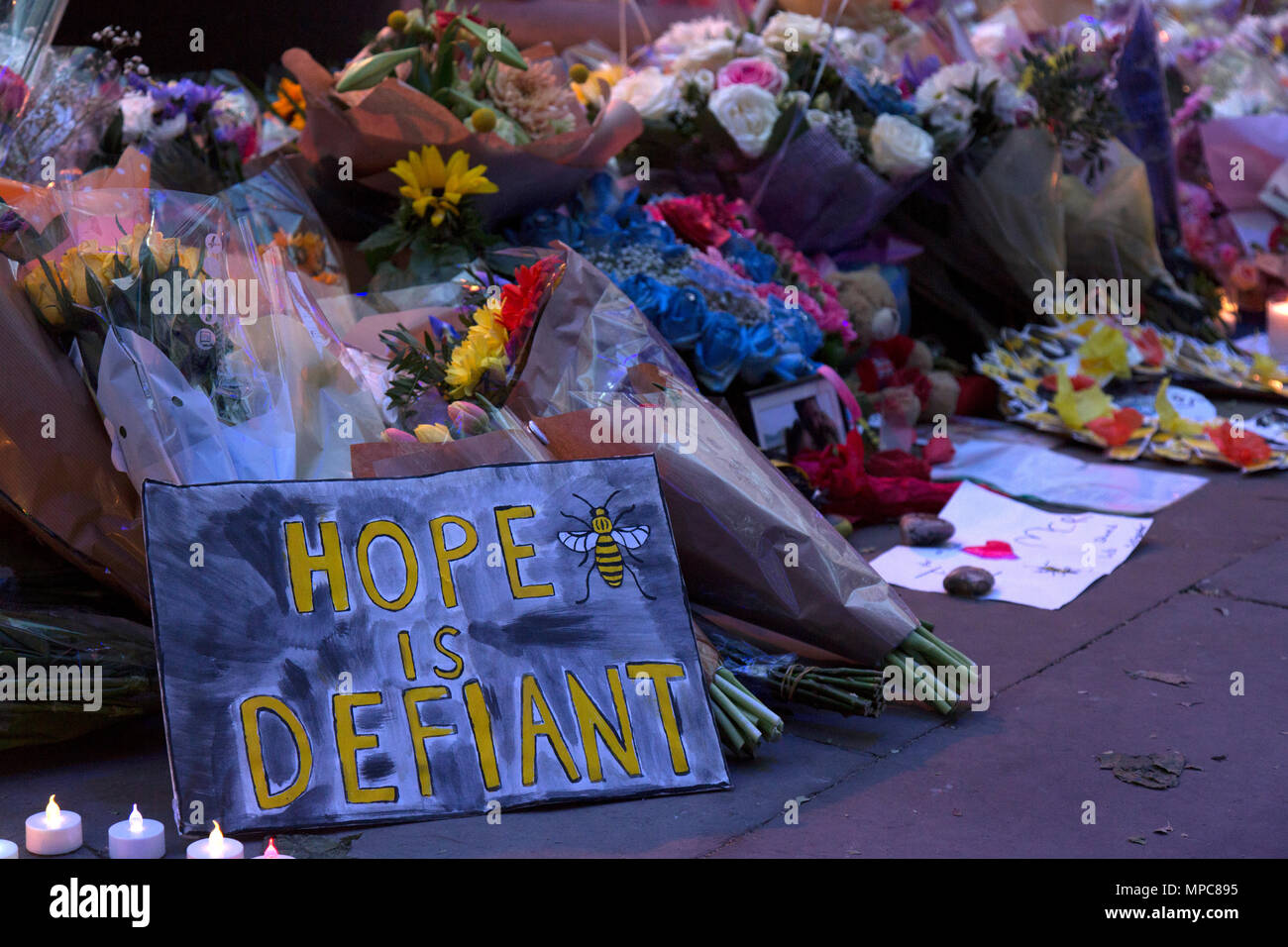 Manchester, UK. 22nd May, 2018. Floral tributes and signs in St. Ann's Square in the center of Manchester, to remember the 22 victims of the bombing of the Manchester Arena, following the conceret given by the American singer Ariana Grande. Credit: Rob Carter/Alamy Live News Stock Photo