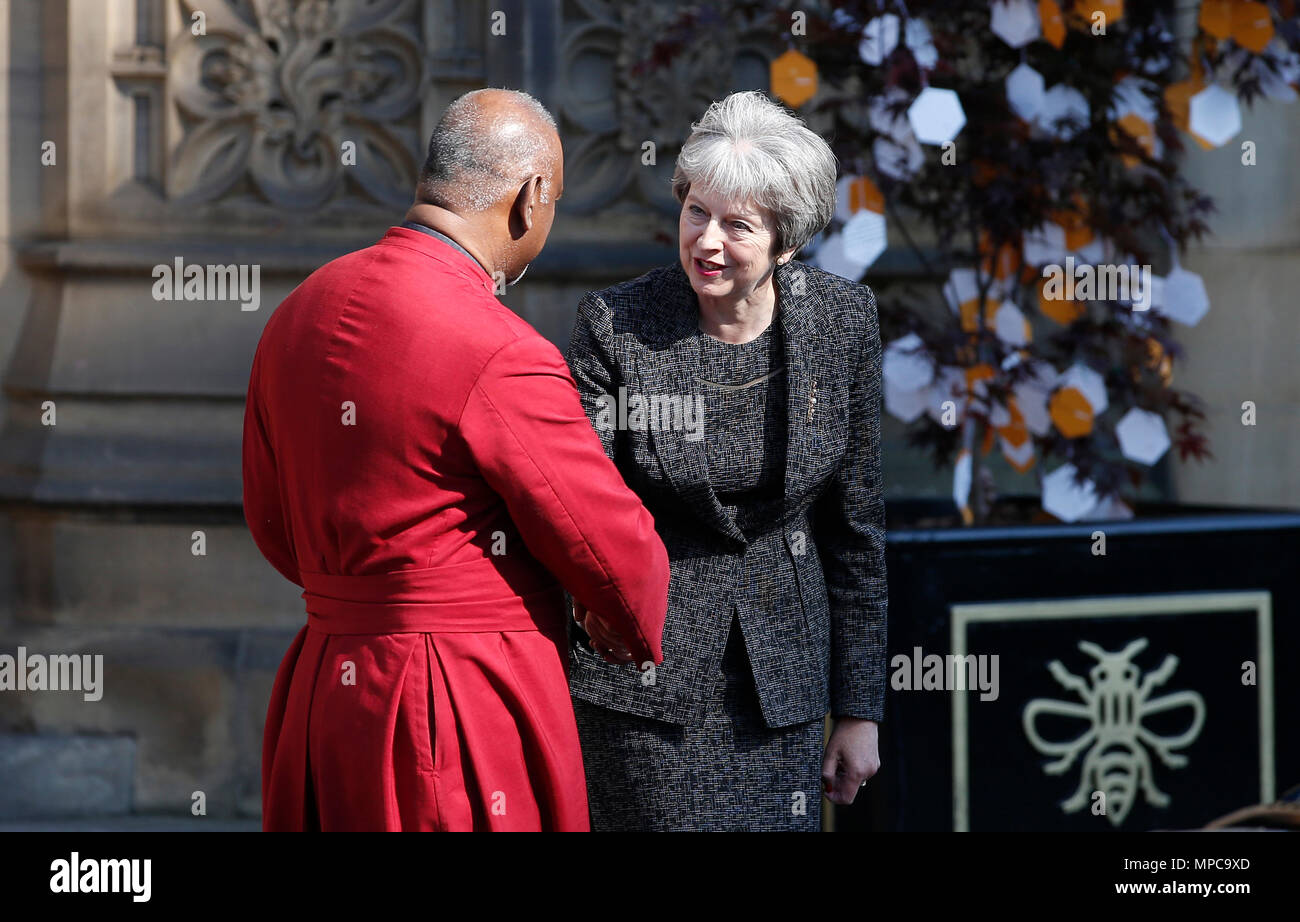 Manchester, Britain. 22nd May, 2018. British Prime Minister Theresa May (R) shakes hands with the Dean of Manchester Rogers Govender as she leaves Manchester Cathedral after the national service of commemoration to remember the victims of the bomb attack in Manchester, Britain, on May 22, 2018. Prince William and British Prime Minister Theresa May joined thousands of people who gathered in Manchester Tuesday on the first anniversary of a terror attack in the city which left 22 people dead. Credit: Craig Brough/Xinhua/Alamy Live News Stock Photo