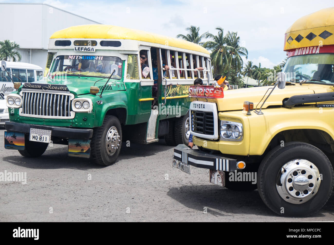 Apia, Samoa - October 30, 2017: People on a colorful vintage bus at Apia bus station on Upolu Island Stock Photo
