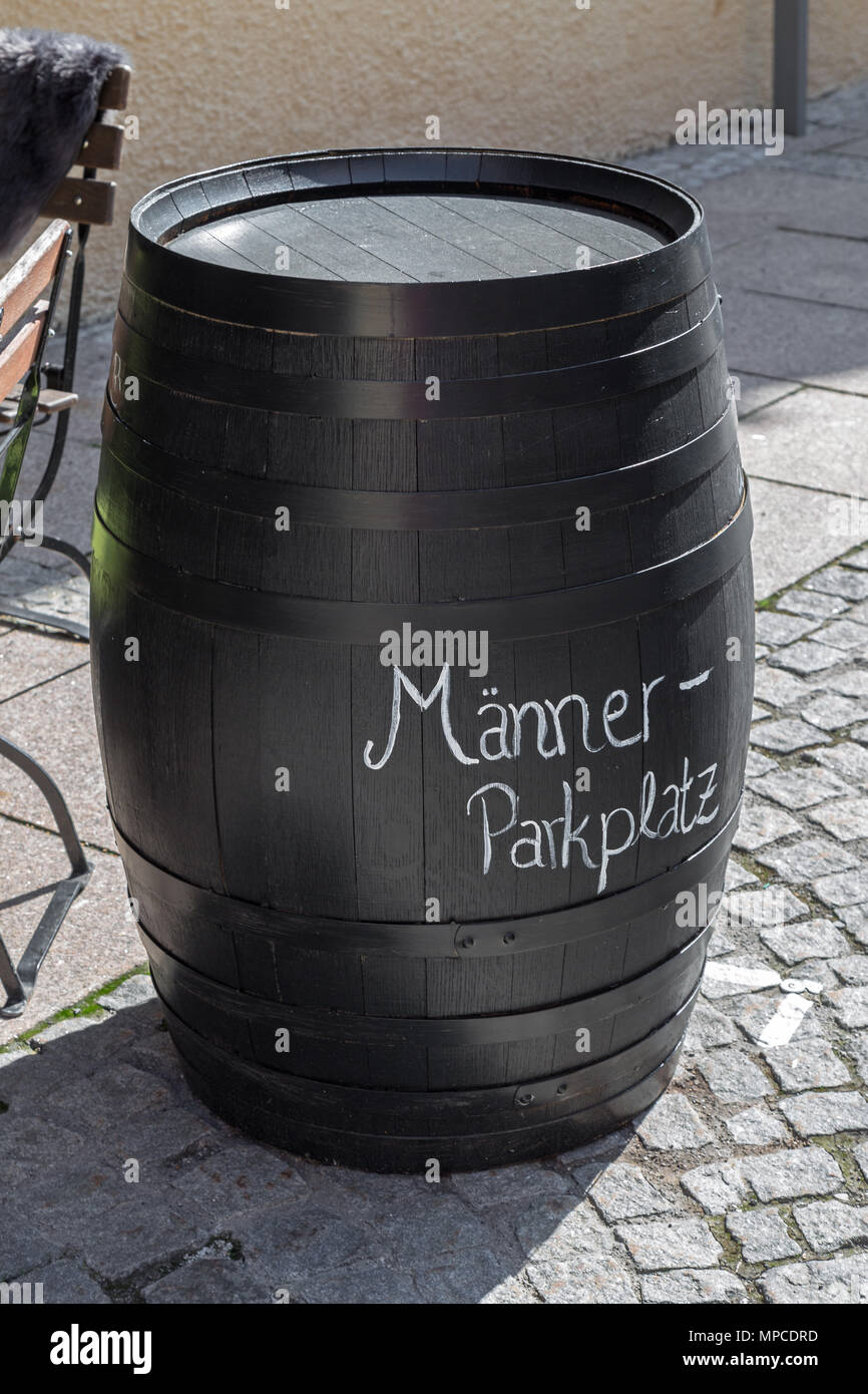 Barrel with german inscription „parking lot for men“ in front of a pub in Bavaria Stock Photo