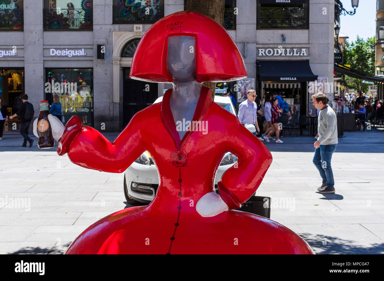 View of a red Menina in Callao square during the celebration of San Isidro, Madrid city, Madrid, Spain. Stock Photo