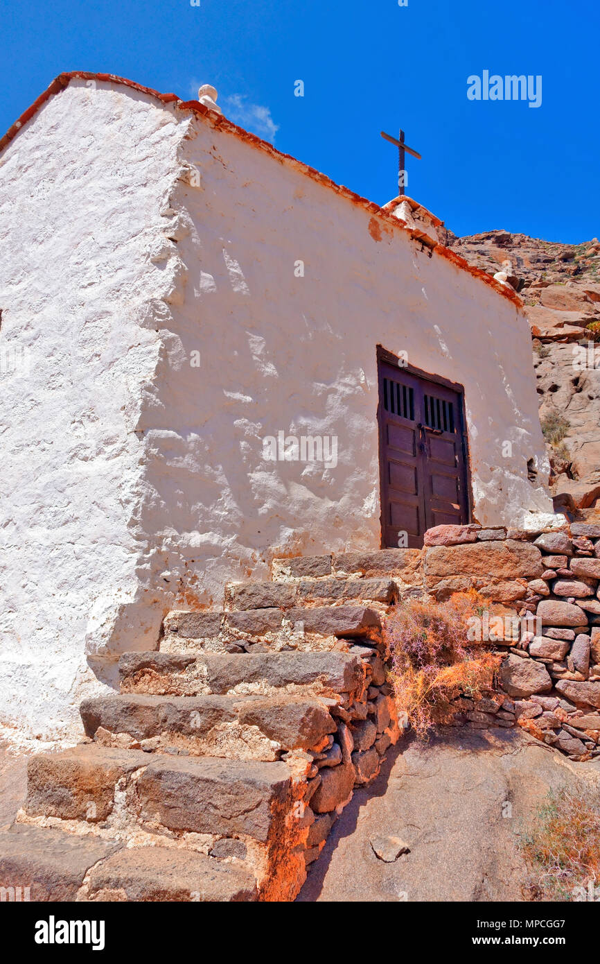 Ermita de la Pena chapel situated in a dramatic rocky Barranco de las Penitas gorge on Fuerteventura, Spain Stock Photo