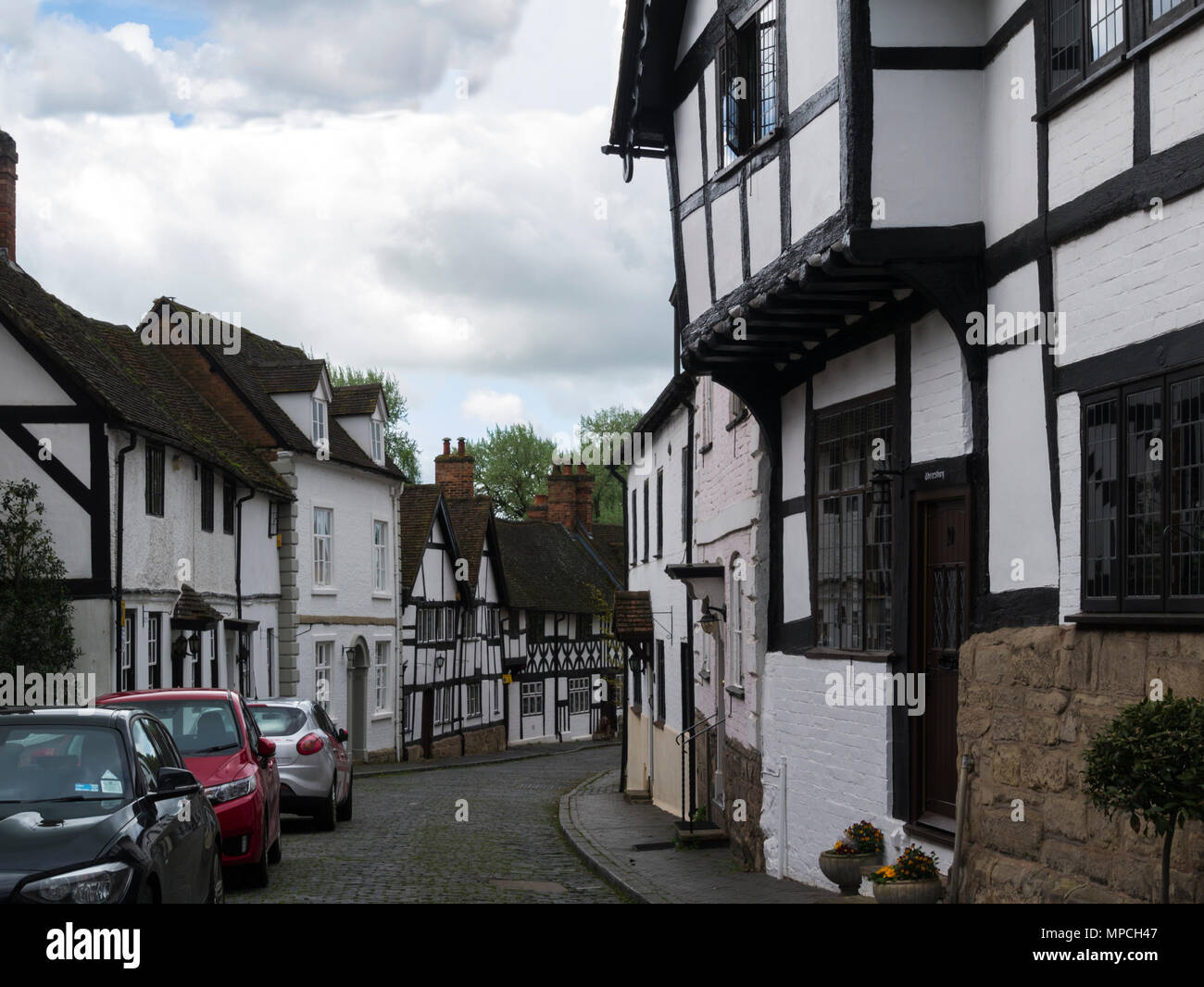 View down Mills Street Warwick Warwickshire England UK with historic black and white buildings